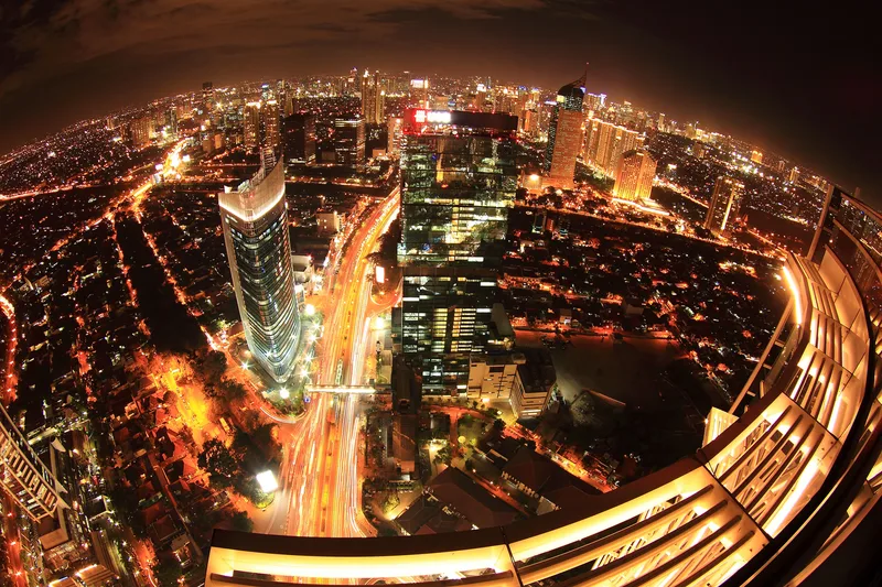 Aerial night view of South Jakarta with high-rise towers and traffic light trails